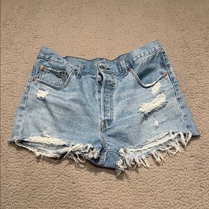 Levi’s 501  high-waisted cutoff denim shorts in a light wash with a raw hem.